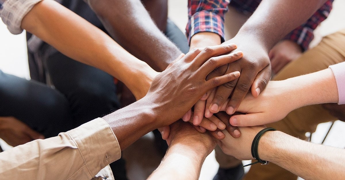 group of people with hands in