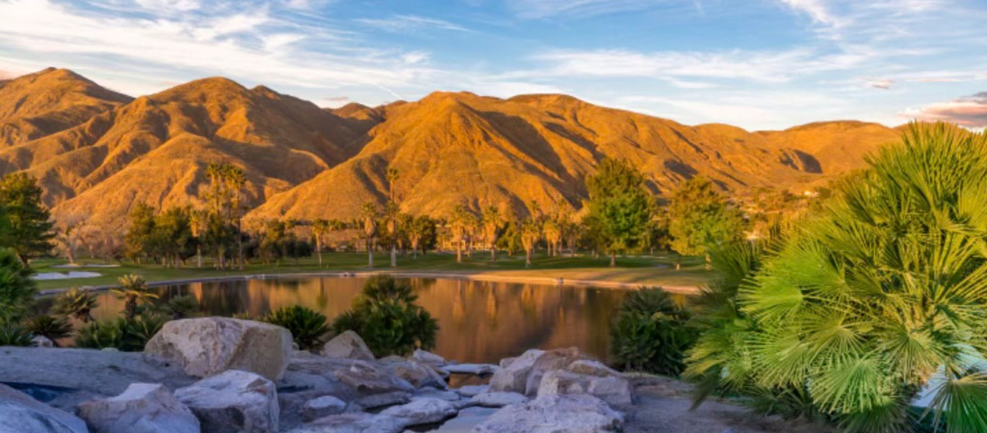 clear lake reflecting mountains and blue sky