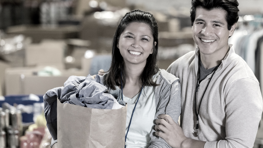 Couple holding a bag of groceries together